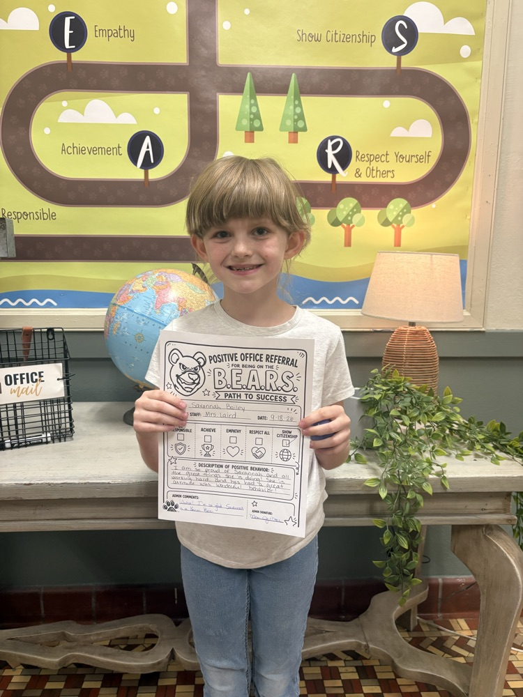 student holding positive office referral
