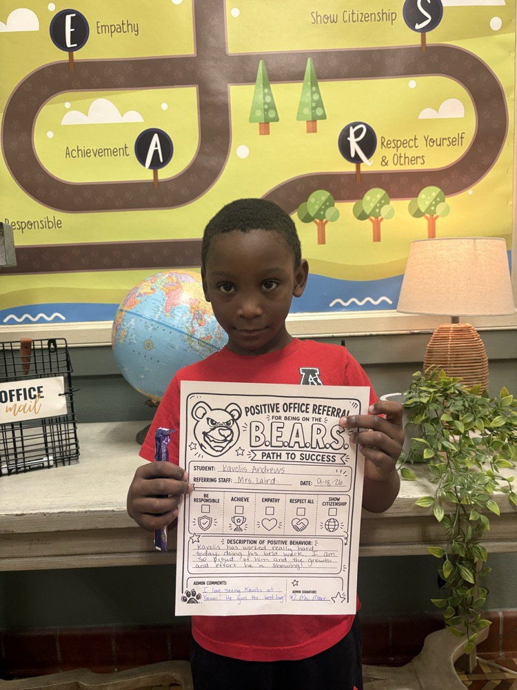 student holding positive office referral