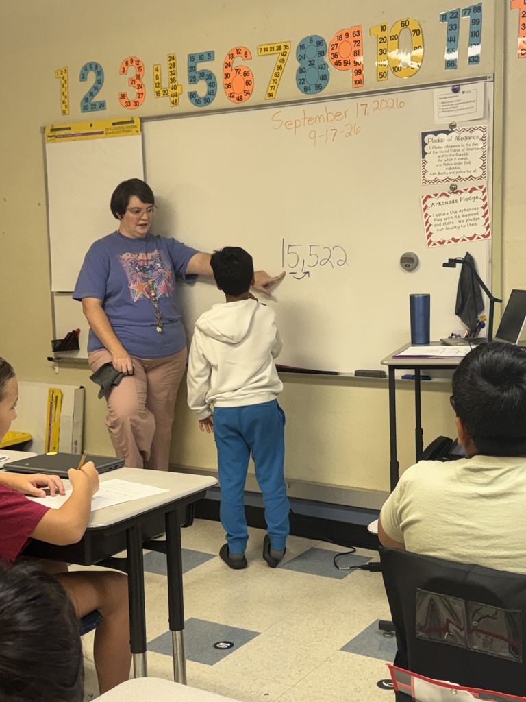 teacher and student working problems on the board