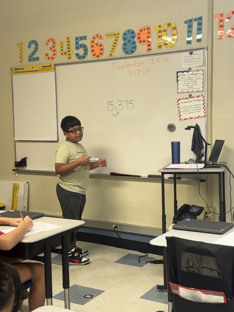 student working a problem on the board