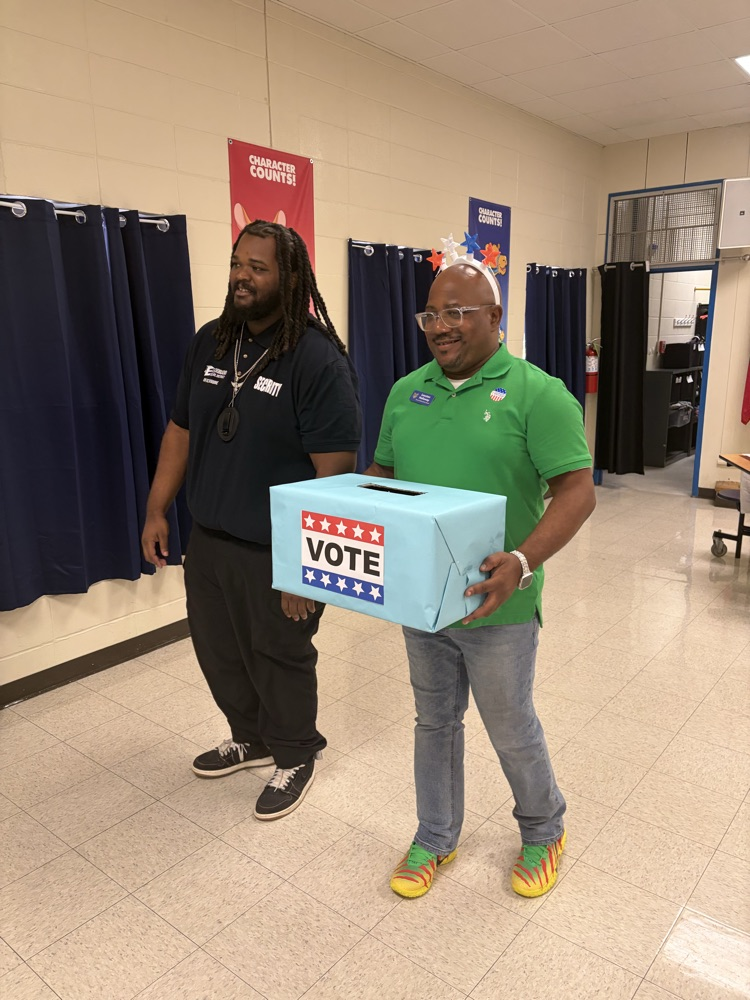 two men carrying a ballot box