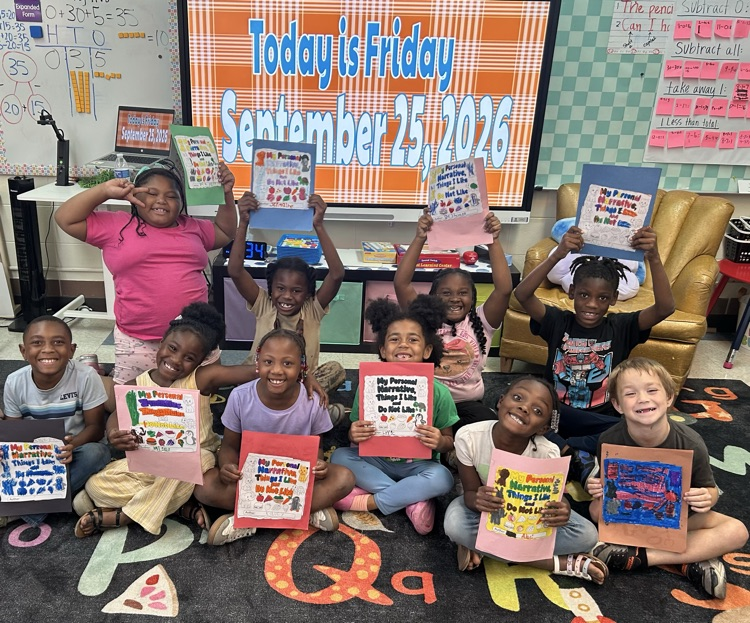 a groups of students holding up books they wrote