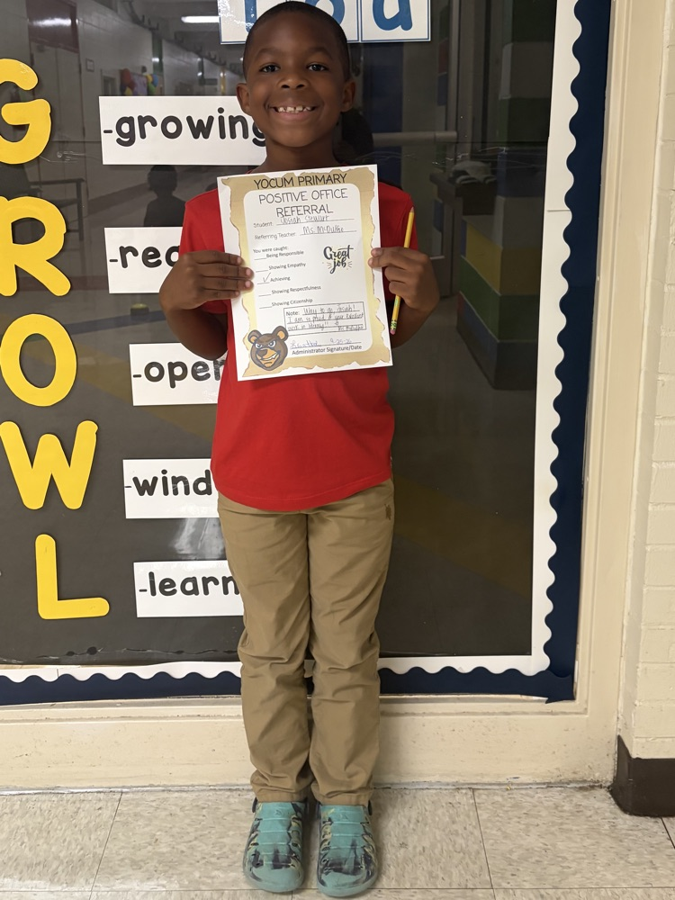 kid holding a positive office referral