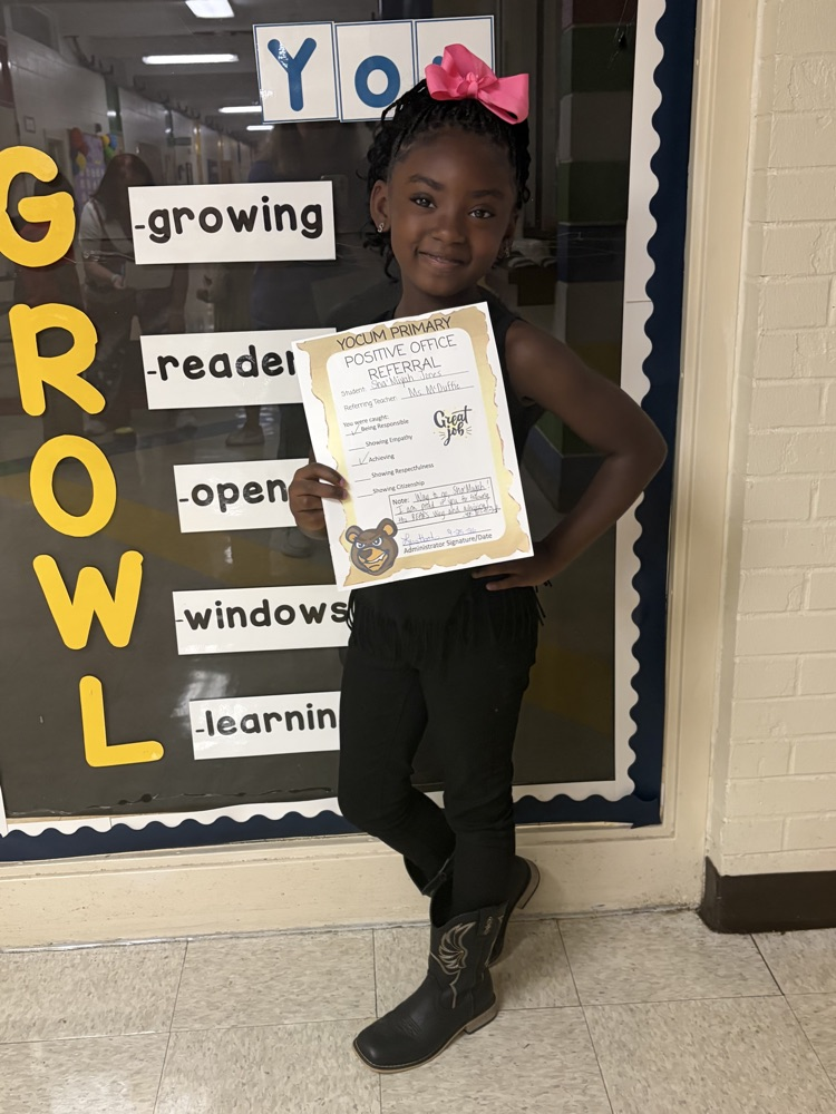 kid holding a positive office referral