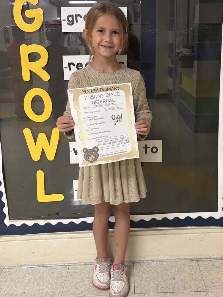 kid holding a positive office referral