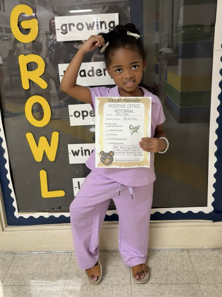 kid holding a positive office referral