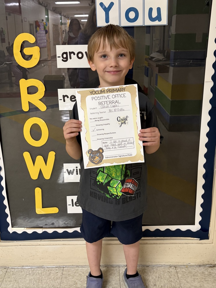 kid holding a positive office referral