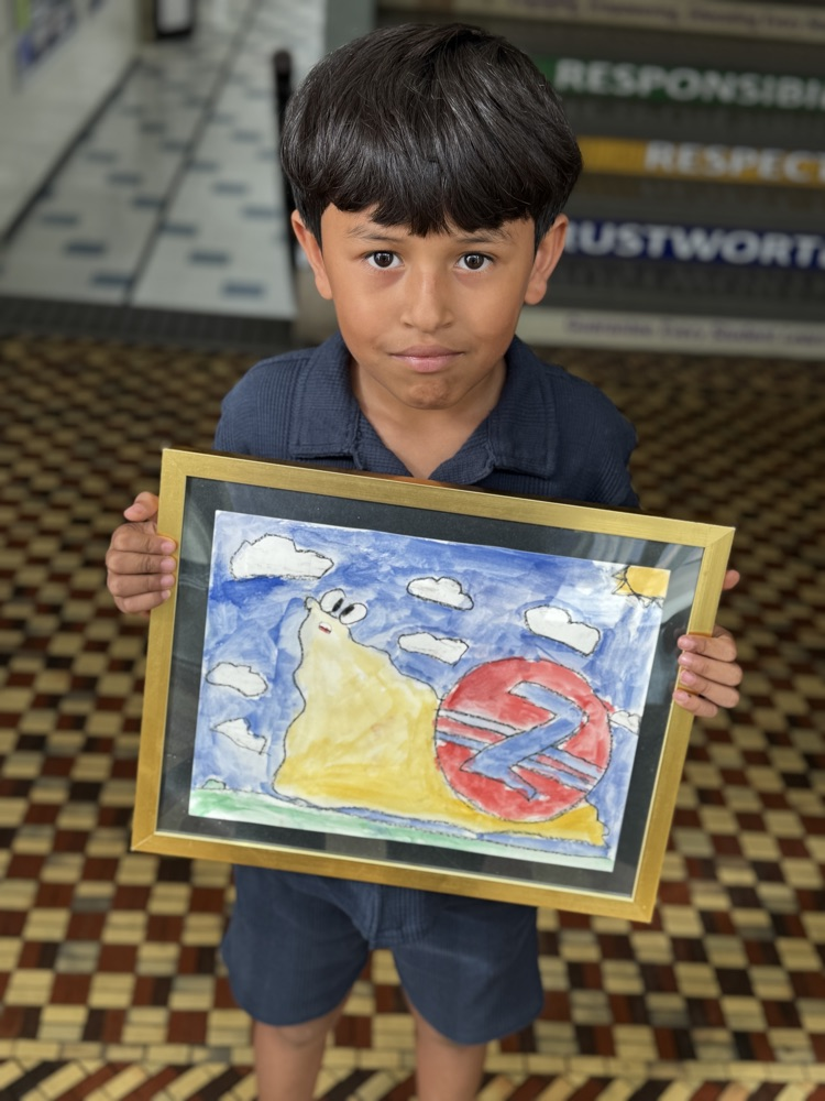 student standing with his painting of a slug