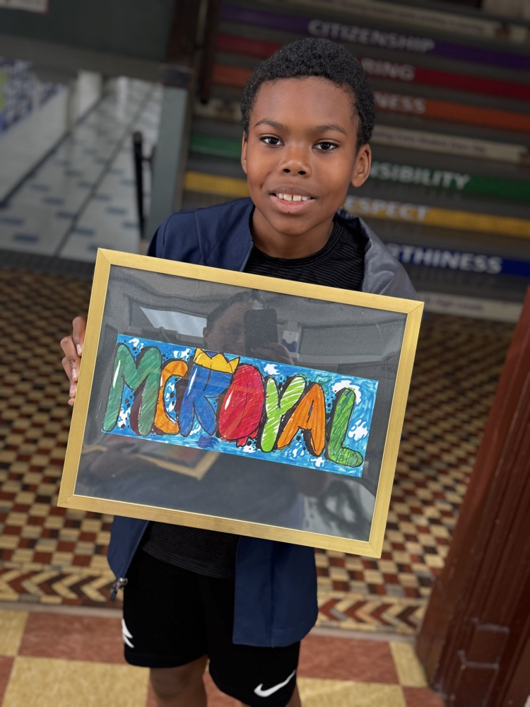 student standing with a picture of the artwork