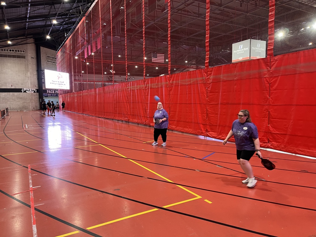 Two El Dorado School District educators practice pickleball together during Special Olympics Arkansas RecFest training.