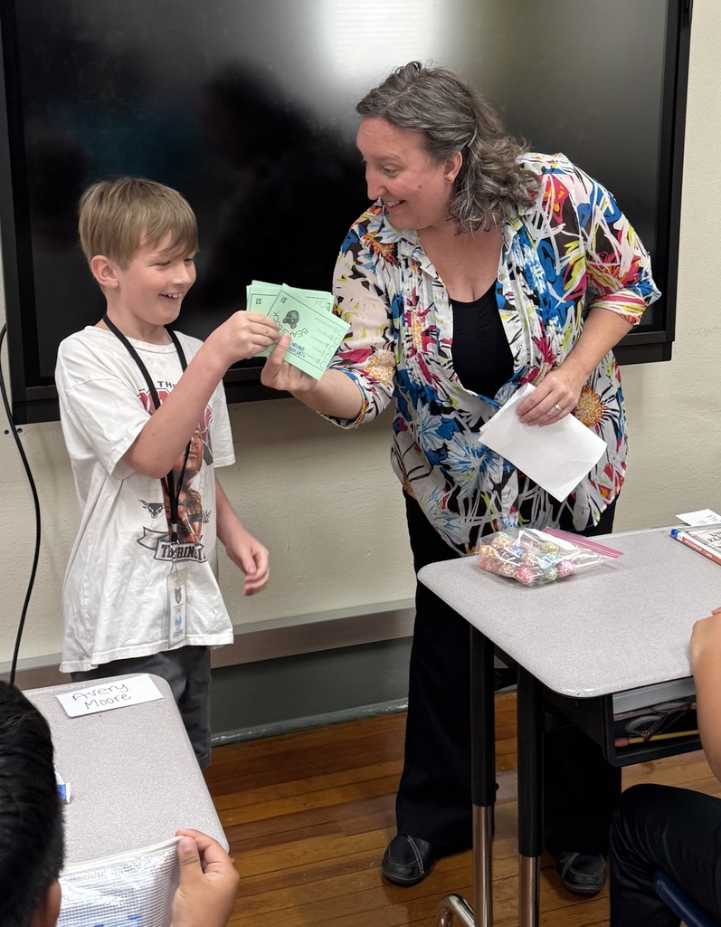 student receiving a prize from an adult
