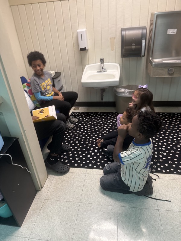 boys reading to kinders