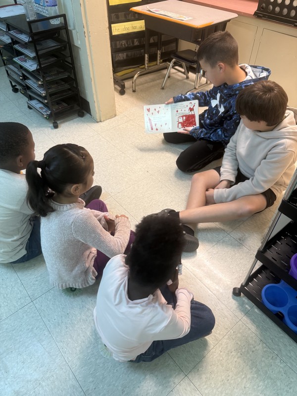 boys reading to kinders