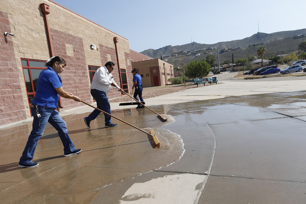 Custodial teams work together to cleanup after rainfall
