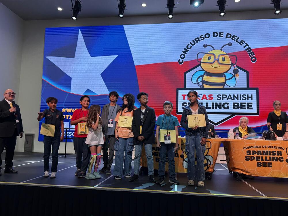 students stand on stage
