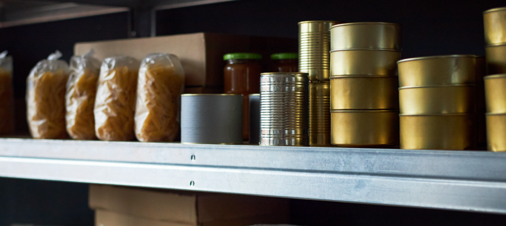 Cans and donated food on shelf.