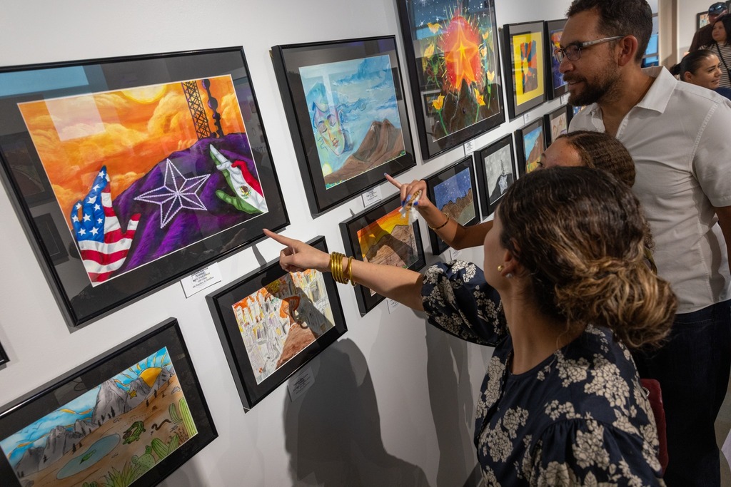Parents point at artwork