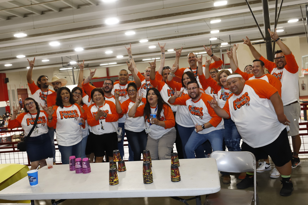 2024 Jefferson Silva Back to School Fiesta staff members take large group photo with hands in the air