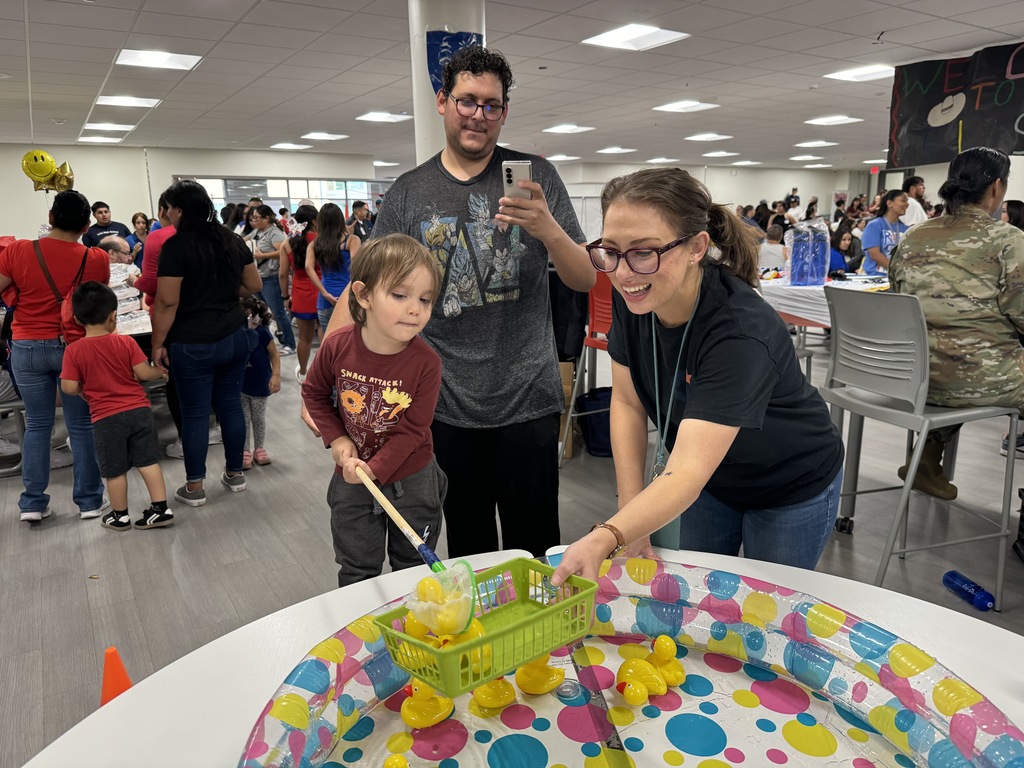 2024 Irvin High School Back to School Fiesta parents and child playing with toy ducks