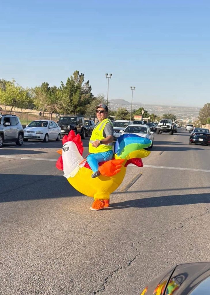 Western Hills Volunteers in Public Schools community members monitor traffic for student safety in inflatable chicken suits