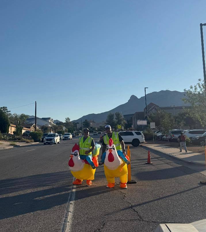 Western Hills Volunteers in Public Schools community members monitor traffic for student safety in inflatable chicken suits