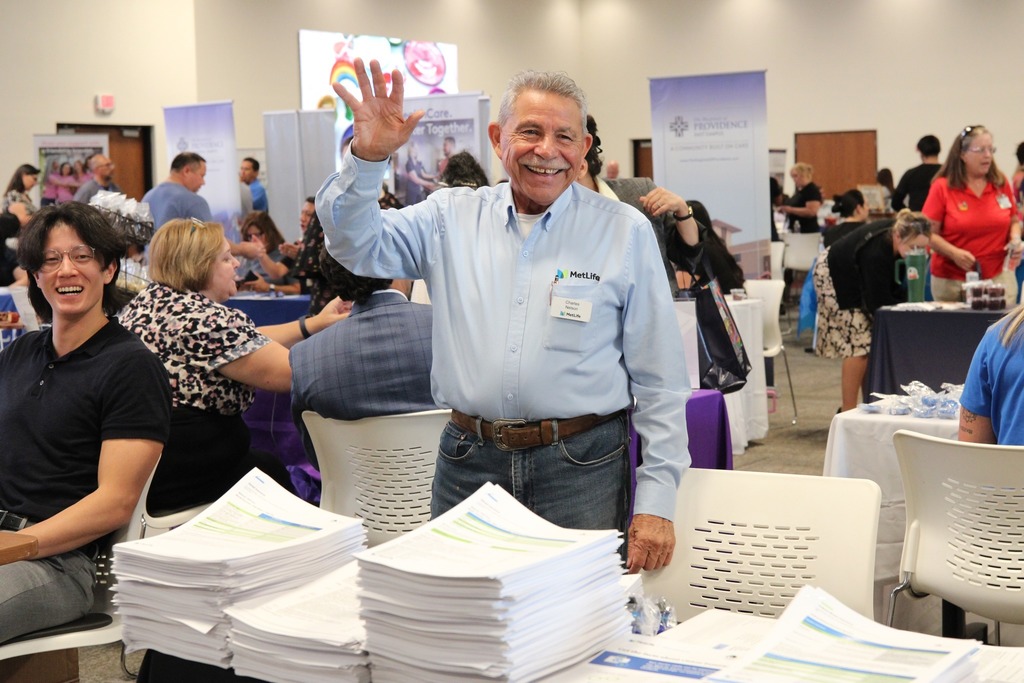 Met Life employee smiles and waves at camera