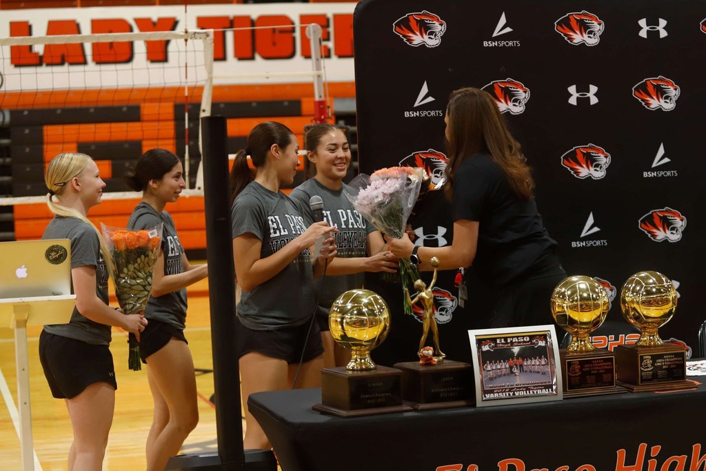 Coach Alarcon receives flowers from her current volleyball players