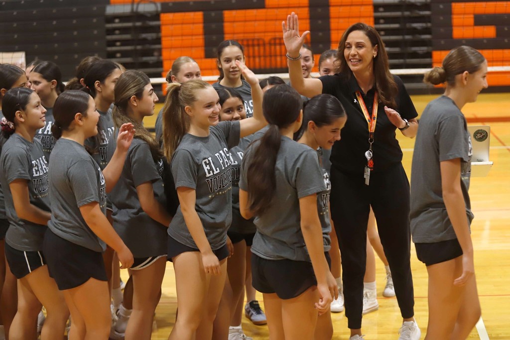 Coach Alarcon high fives her current El Paso High School volleyball team