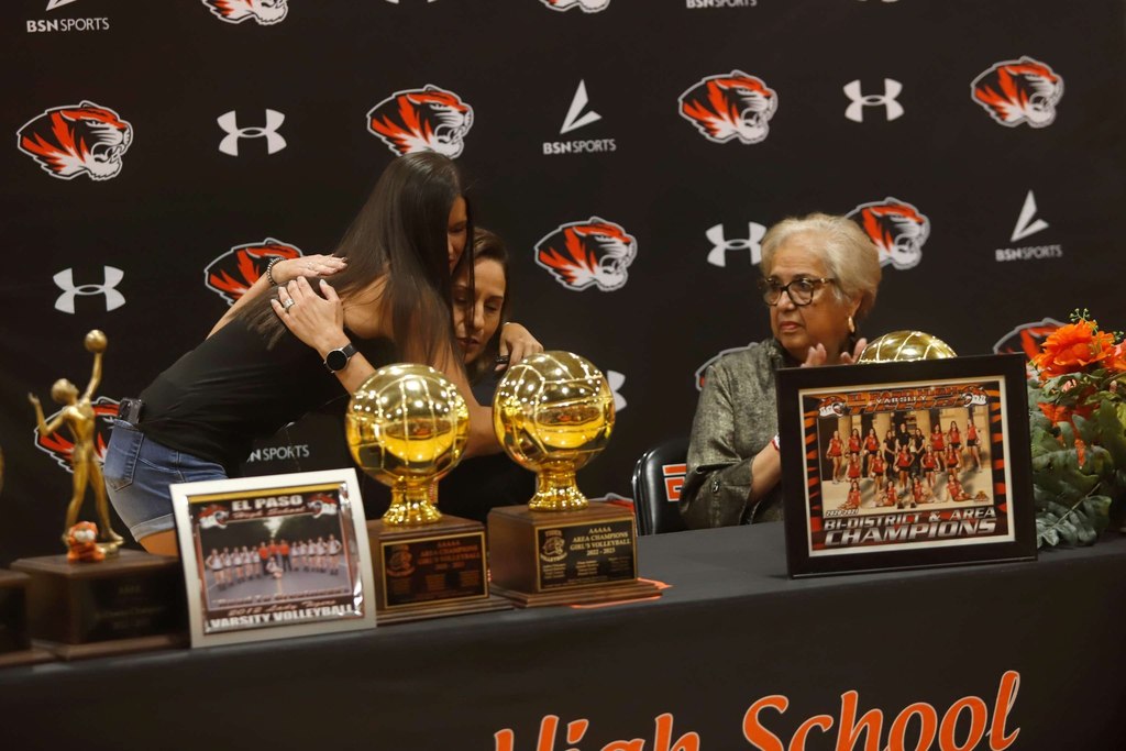Coach Alarcon receives a hug from a previous volleyball student