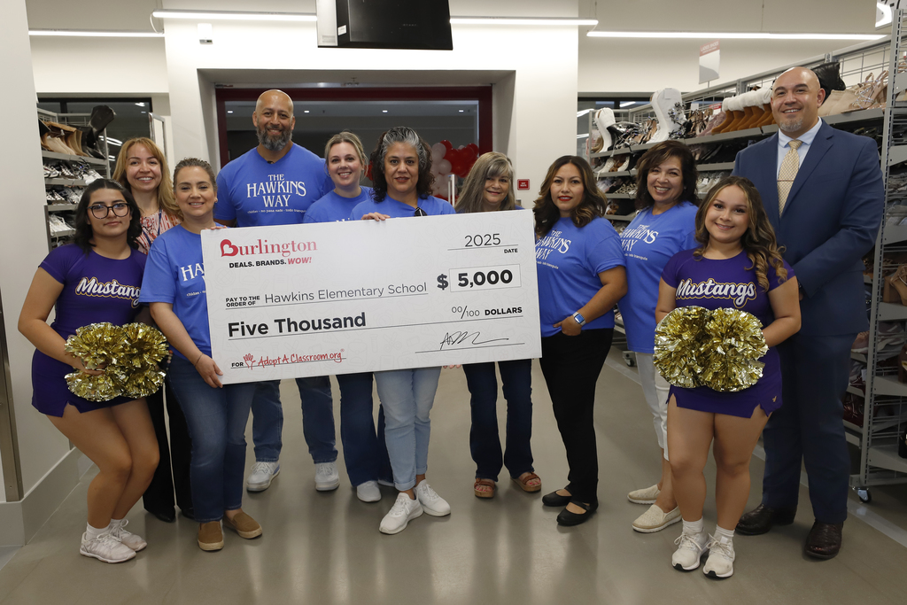 Hawkins staff, Burges cheerleaders, and EPISD board member Alex Cuellar take group photo with Hawkins Elementary check