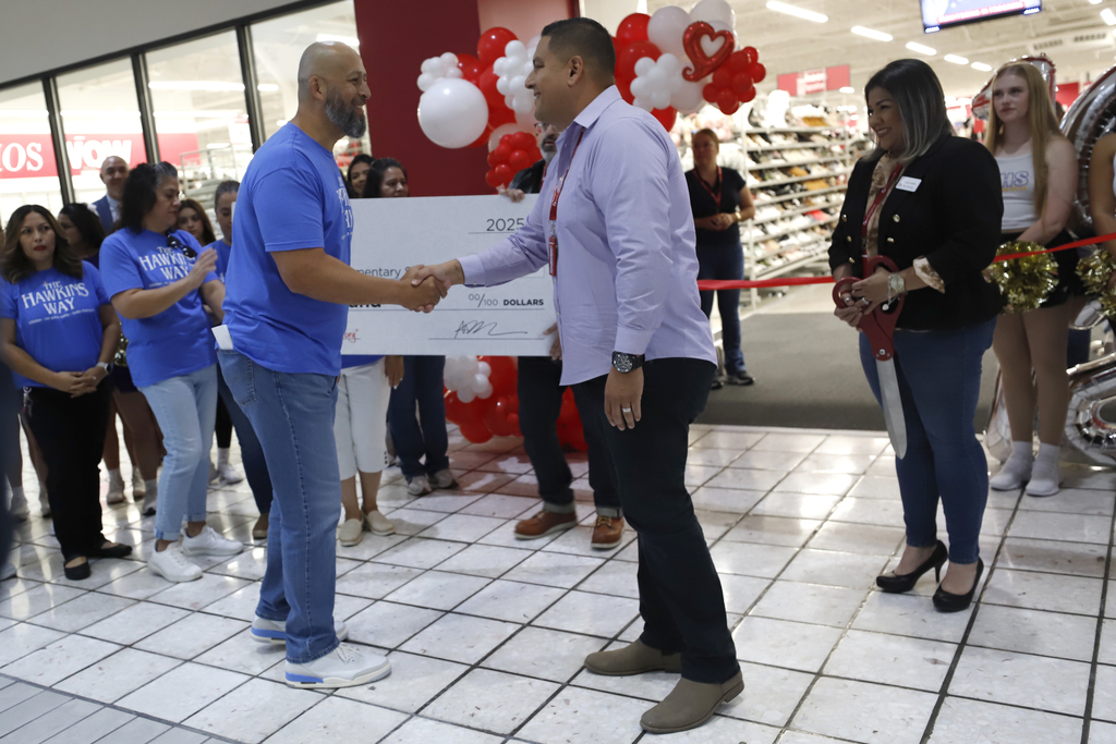 Hawkins Principal Rafael Guardado shakes hands with Burlington representative