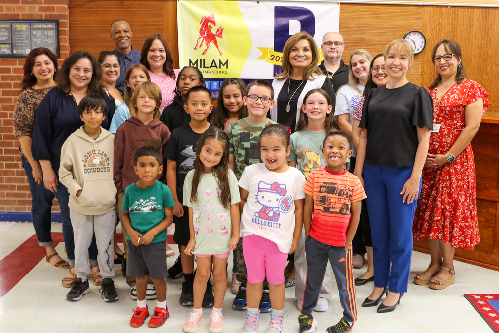 Milam Elementary School students, staff, Interim Superintendent Martha Aguirre, and EPISD leadership take photo with the school's B-rated campus banner
