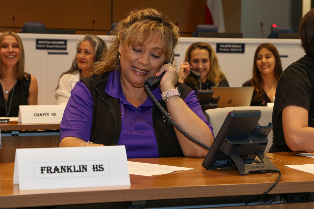 Staff member answering calls at Operation Search Telethon