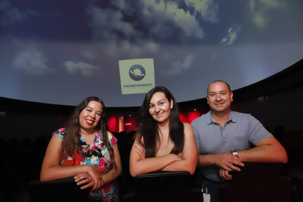 Planetarium staff members smile for a group photo