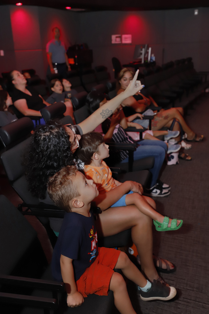 Families looks up at Planetarium screen