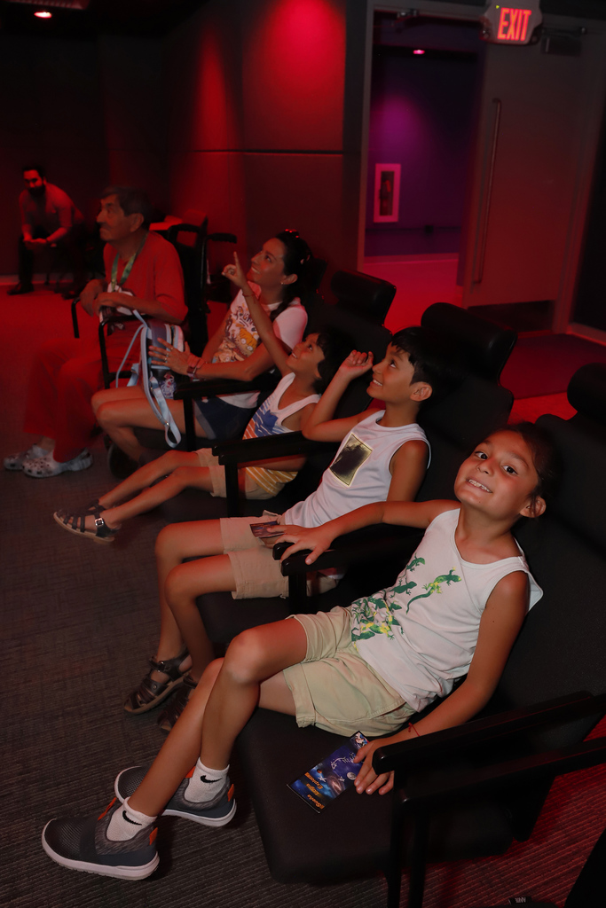 Families looks up at Planetarium screen