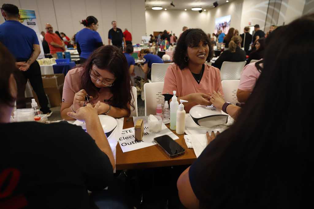 CCTE students giving manicures to El Paso ISD Employee Health Fair attendees