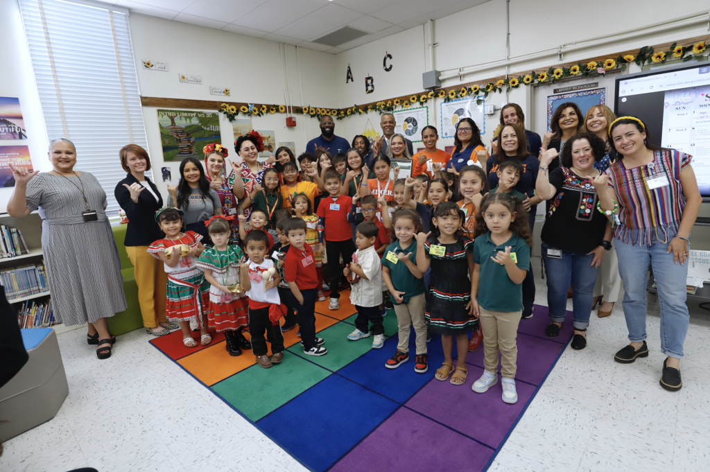 Group photo of Douglass Elementary School students and staff, El Paso ISD leadership, and Interim Superintendent Martha Aguirre, and  representatives from UTEP Athletics
