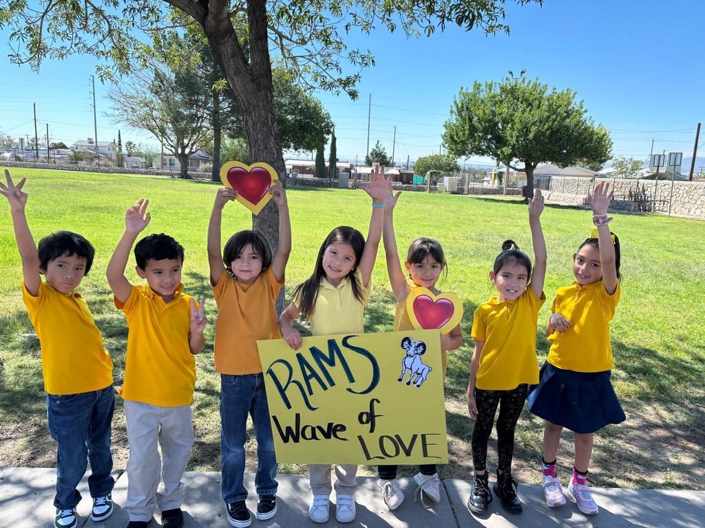 Students smiling for a group photo wearing gold for Childhood Cancer Awareness Month