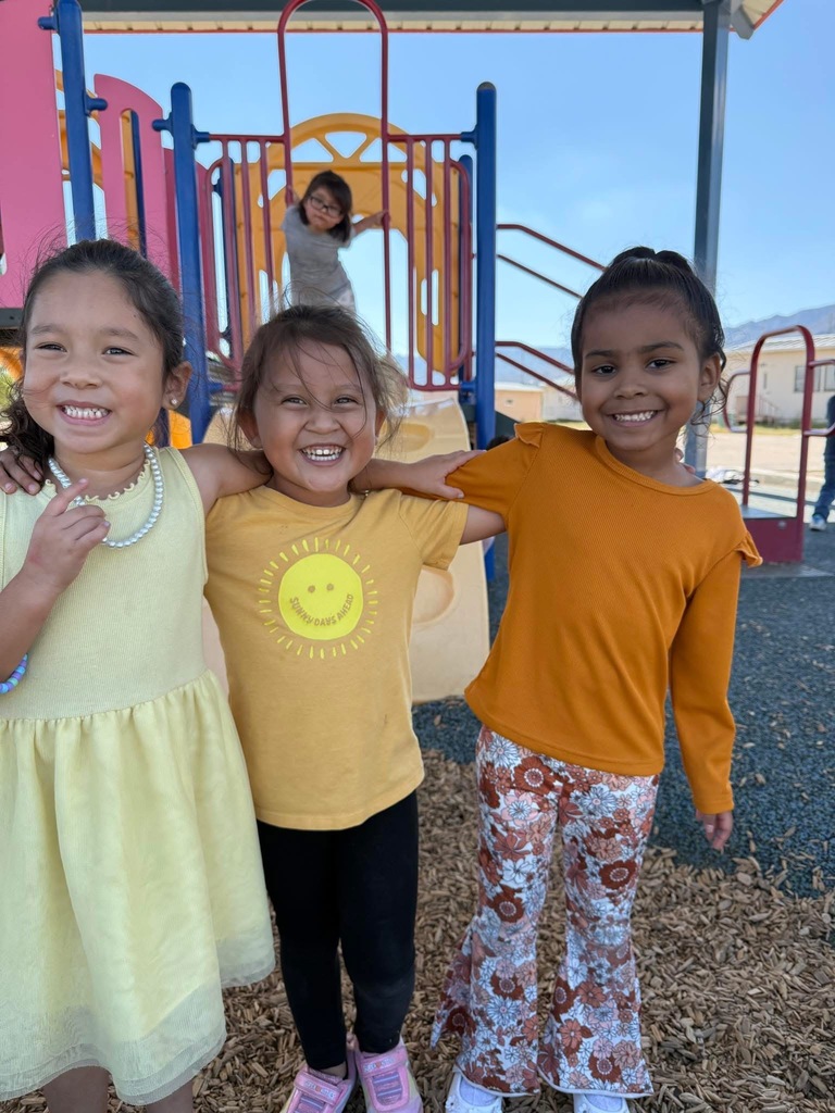 Students smiling for a group photo wearing gold for Childhood Cancer Awareness Month