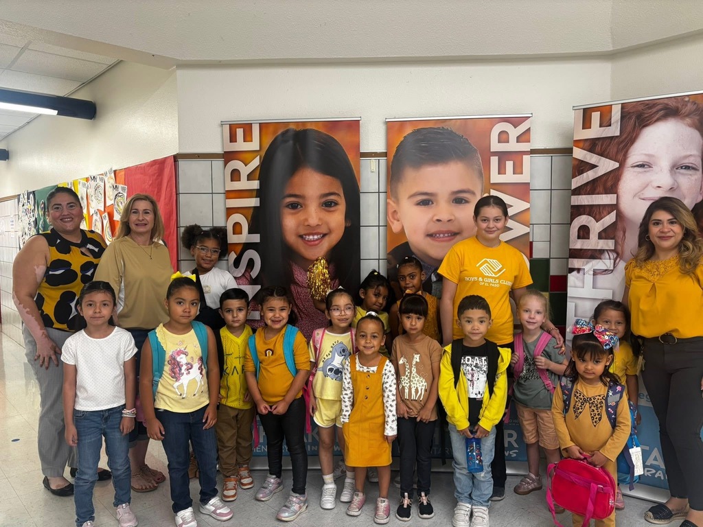 Students smiling for a group photo wearing gold for Childhood Cancer Awareness Month