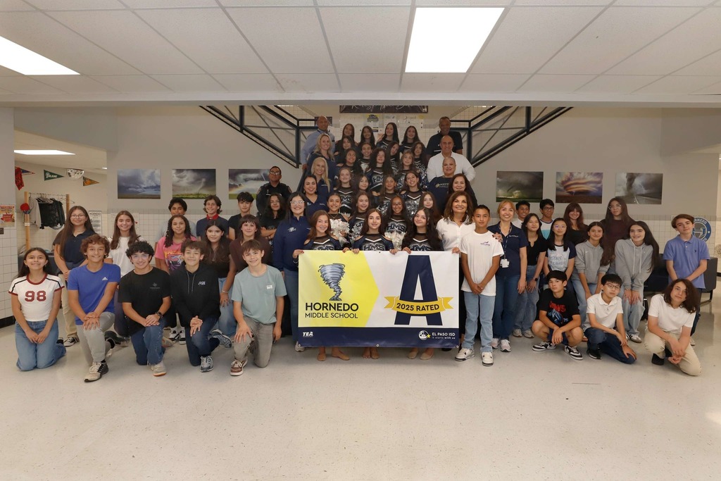 Hornedo Middle School takes group photo with a-rated campus banner