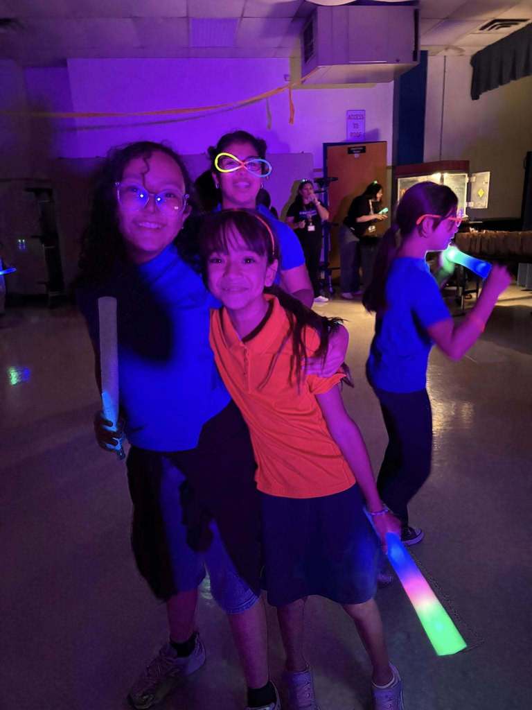Hawkins students smiling with glow sticks