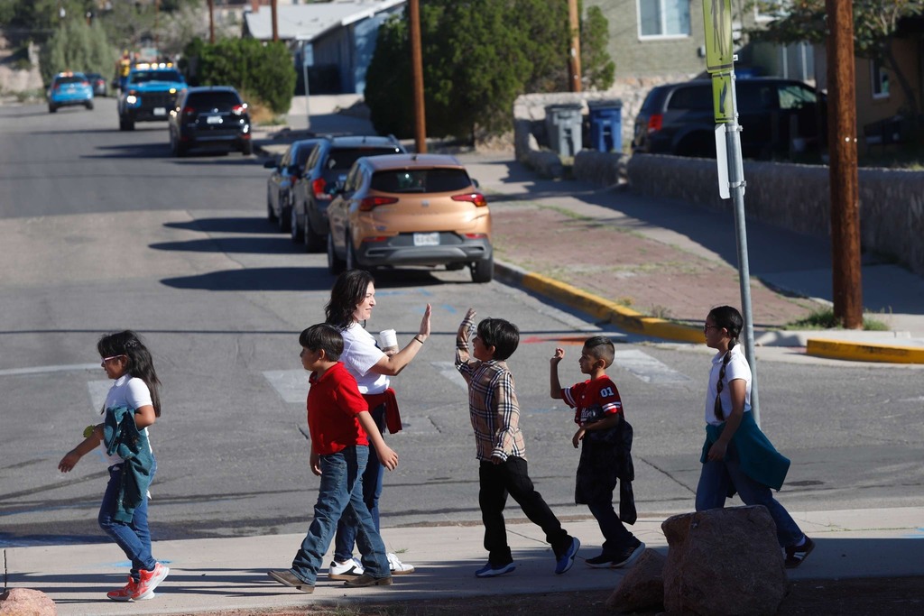 Moreno students walking and high fiving staff member