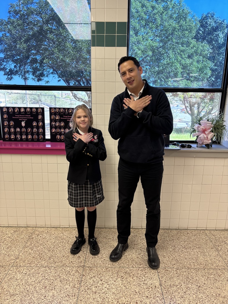 Job Gracia and student whose life he saved showing the universal sign of choking