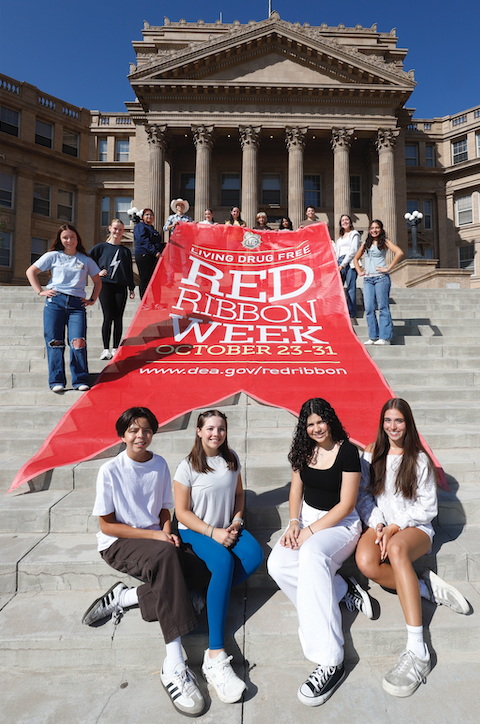 El Paso High School students pose with giant DEA red ribbon for Red Ribbon Week