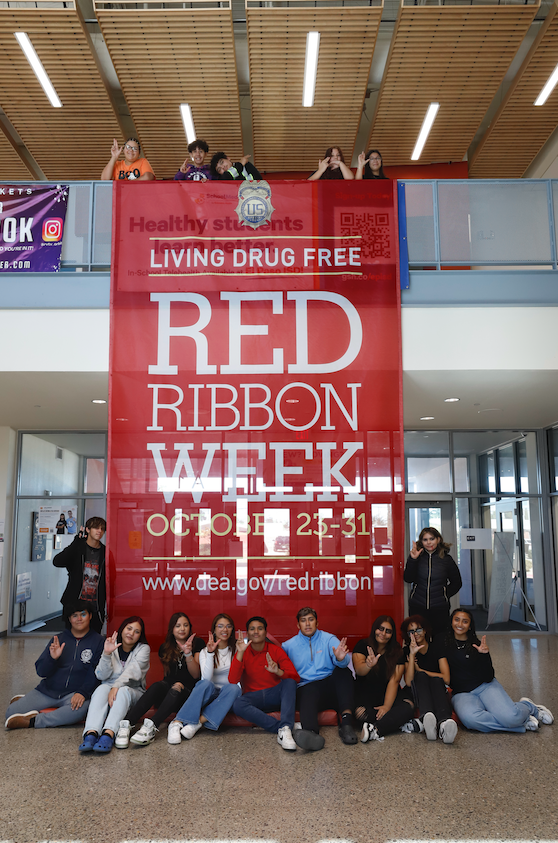 Irvin High School students pose with giant DEA red ribbon for Red Ribbon Week