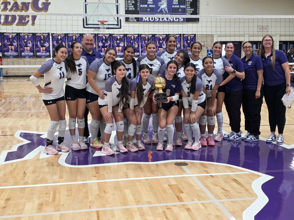 Burges High School volleyball team takes group photo with bi-district trophy
