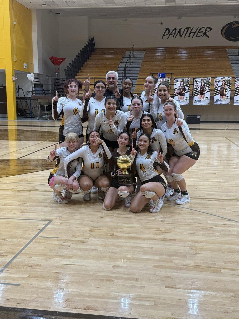 Austin High School volleyball team takes group photo with bi-district trophy