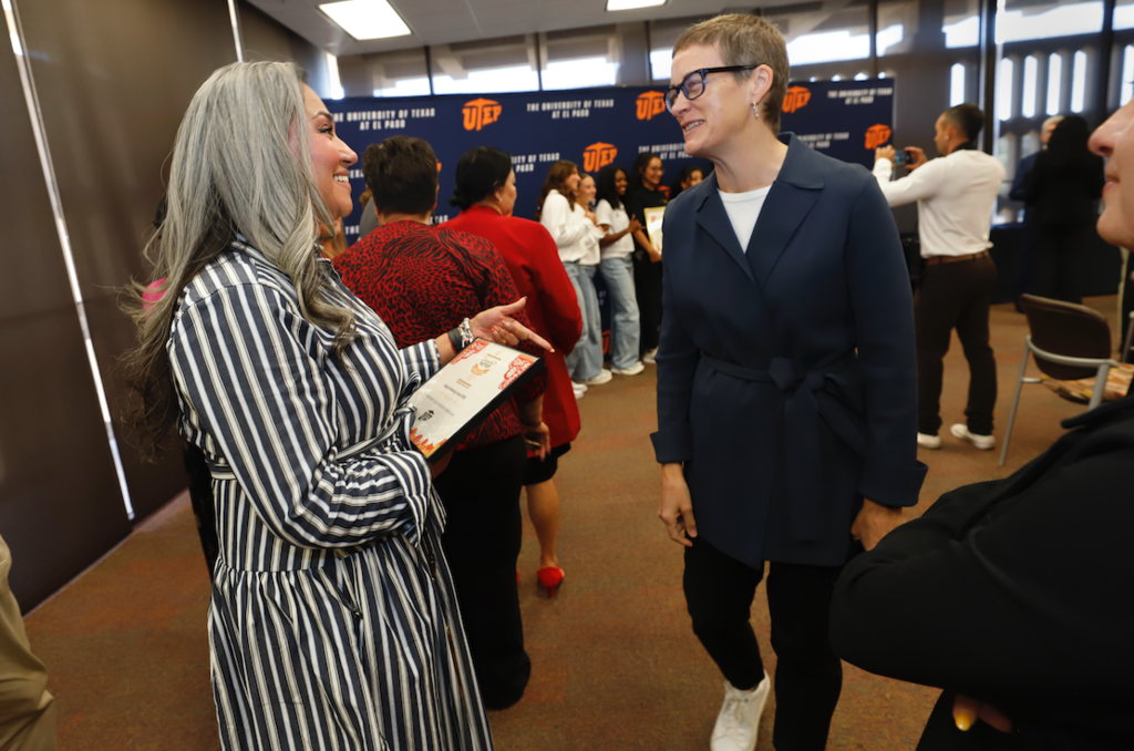Douglass principal speaking to another person